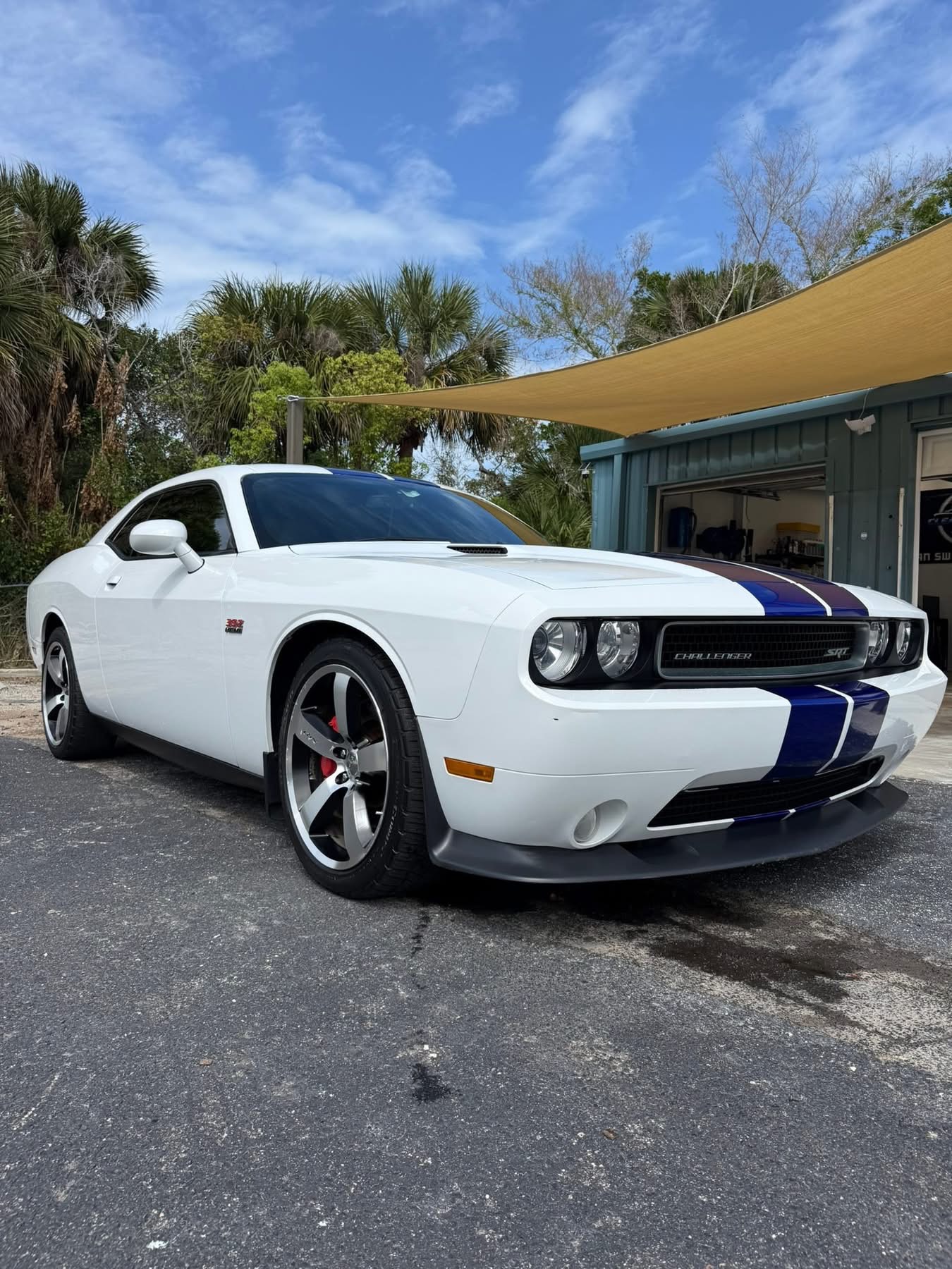 White Dodge Challenger SRT with blue stripes photographed outdoors from the Clean Sweep Detailing portfolio